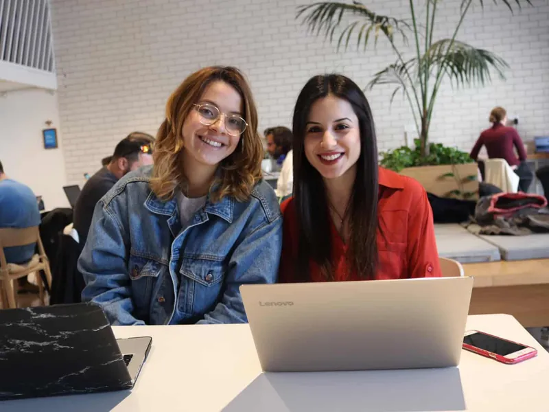 Two Aardvark Israel Tech Track students working on laptops in a tech office